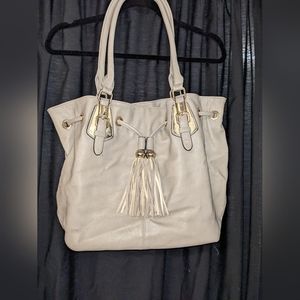Beautiful leather hobo bag. Tassled drawstring closure. Gold hardware.